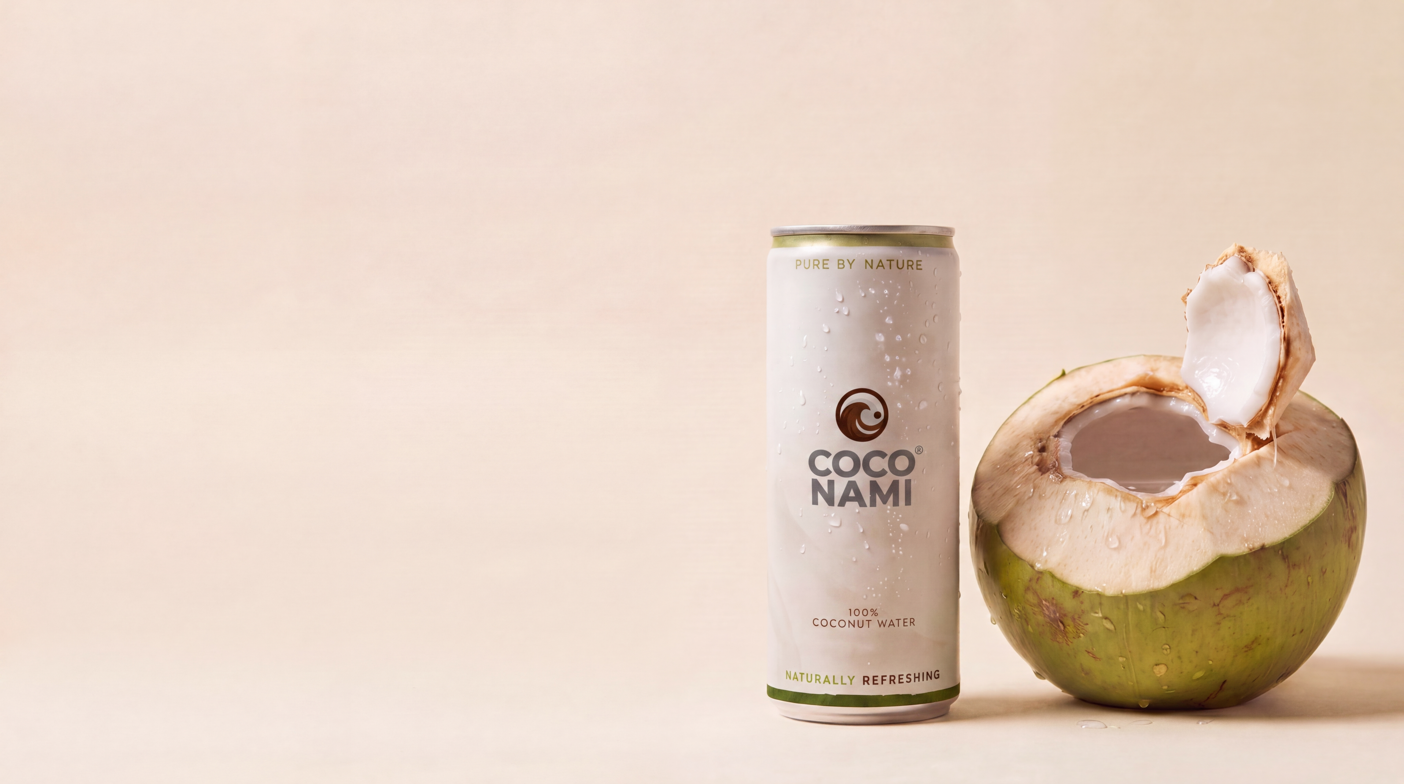 Coconami can next to a freshly opened Nam Hom coconut
